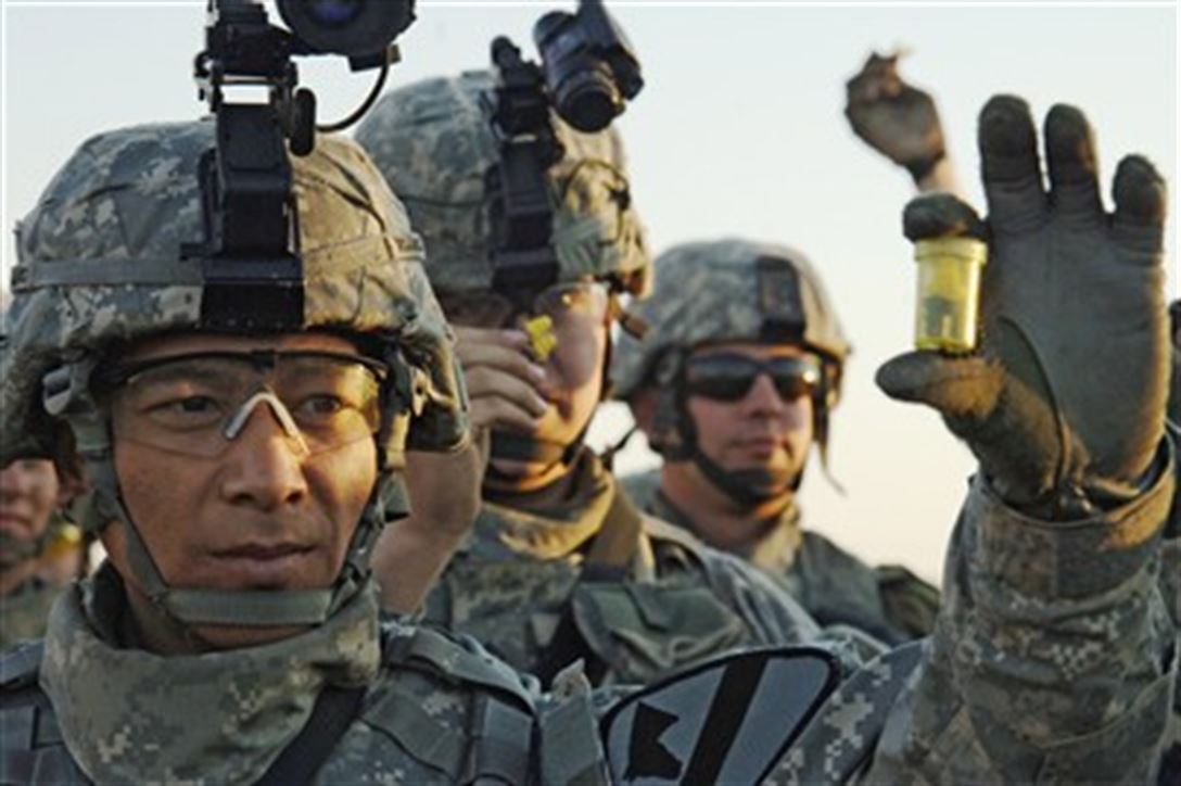 Pfc. Douglas Wojtowicz and fellow soldiers show their combat ear plugs.