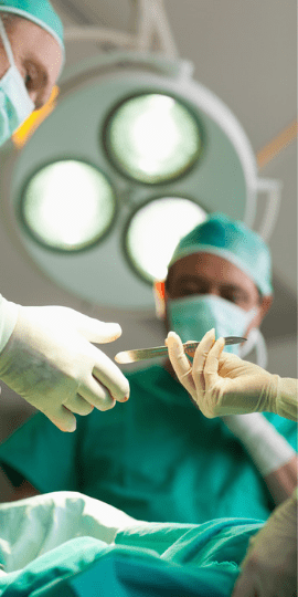 Surgeons apply a hernia mesh